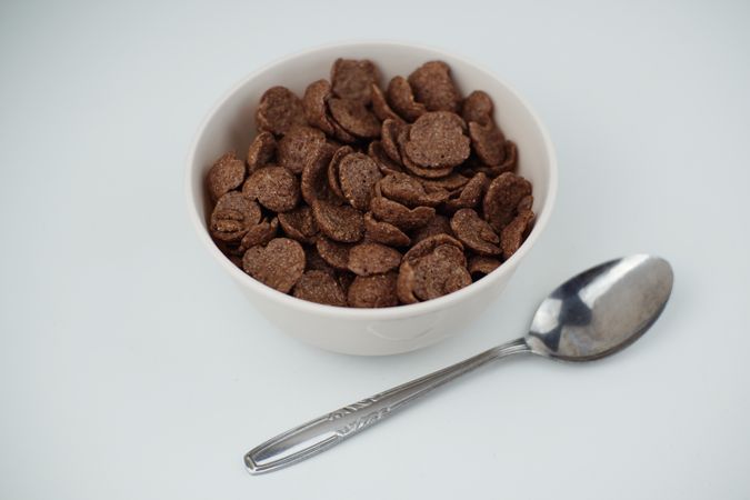 A bowl of chocolate flakes on a light background