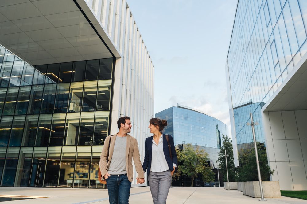 Businesspeople couple outside contemporary building