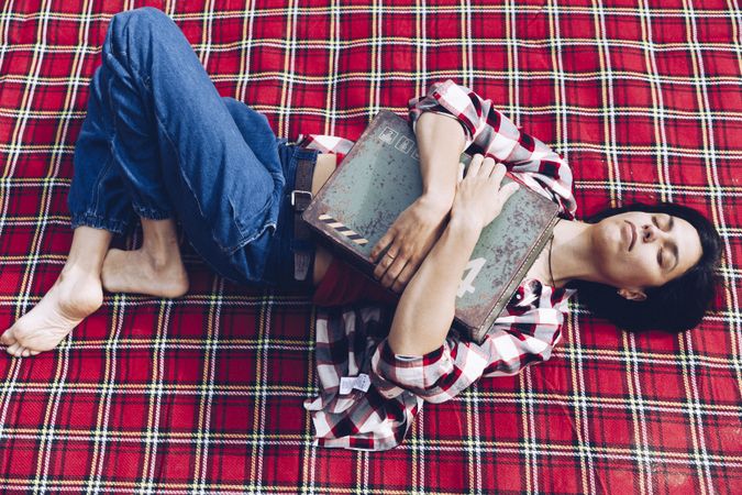 Cheerful woman with old case on picnic
