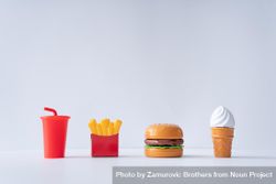 Plastic fast food items on light background 0WElx4