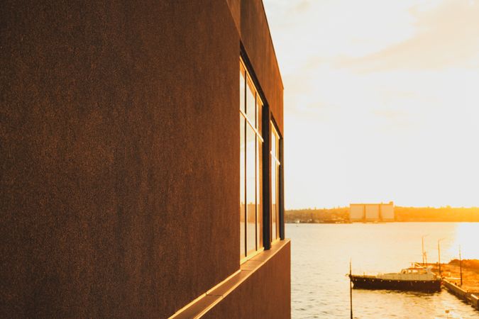 building with empty wall near the river. Amazing sunset