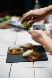 Man grating lime zest onto desert