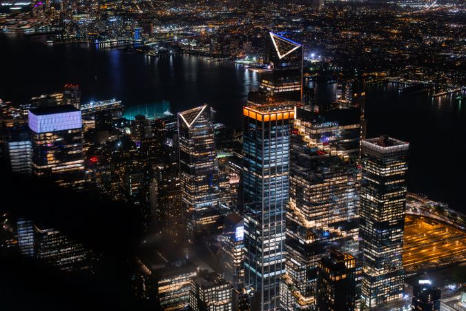 Scenic Aerial New York City View of Downtown Manhattan Architecture. Panoramic Photo of the Business District from a Helicopter. Cityscape with Buildings with Lights in Offices at Night
