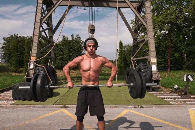 Man with barbell in outdoor gym