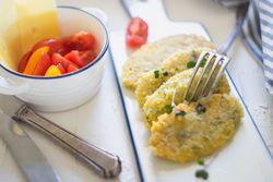 Homemade cheese sticks served with cherry tomatoes, herbs and cheese