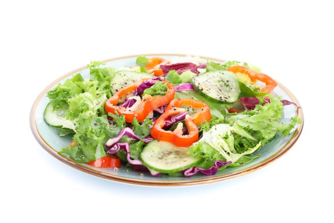 Plate with fresh salad isolated on plain background