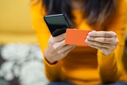 Close up of female using her phone to shop online