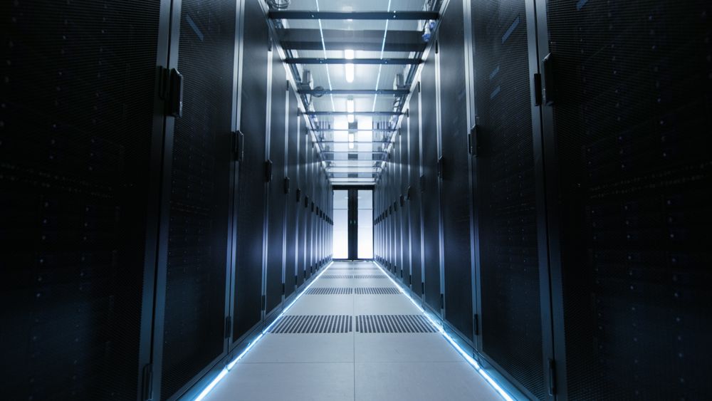 View Through Big Working Data Center with Server Racks.