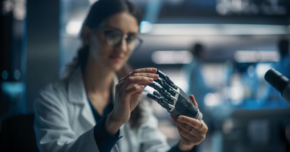 Young Female Scientist Working in Technological Research and Development Company, Assembling an Innovative Bionic Prosthetic Hand.