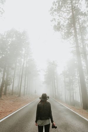 Woman with camera in forest