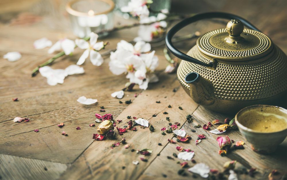 Oriental teapot with teacups and dried flowers