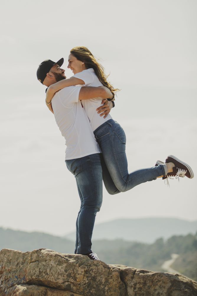 Loving couple embracing while standing at mountain cliff