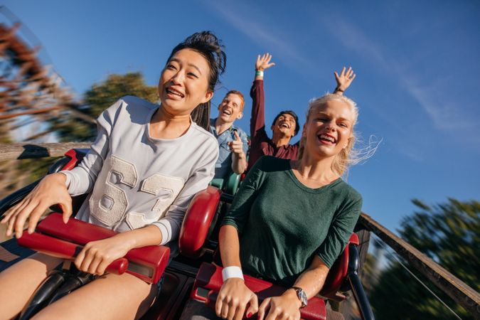 Young people on a thrilling roller coaster ride