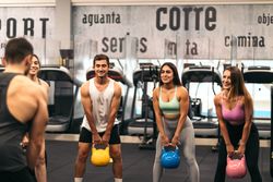 fitness class lifting kettlebells in a gym