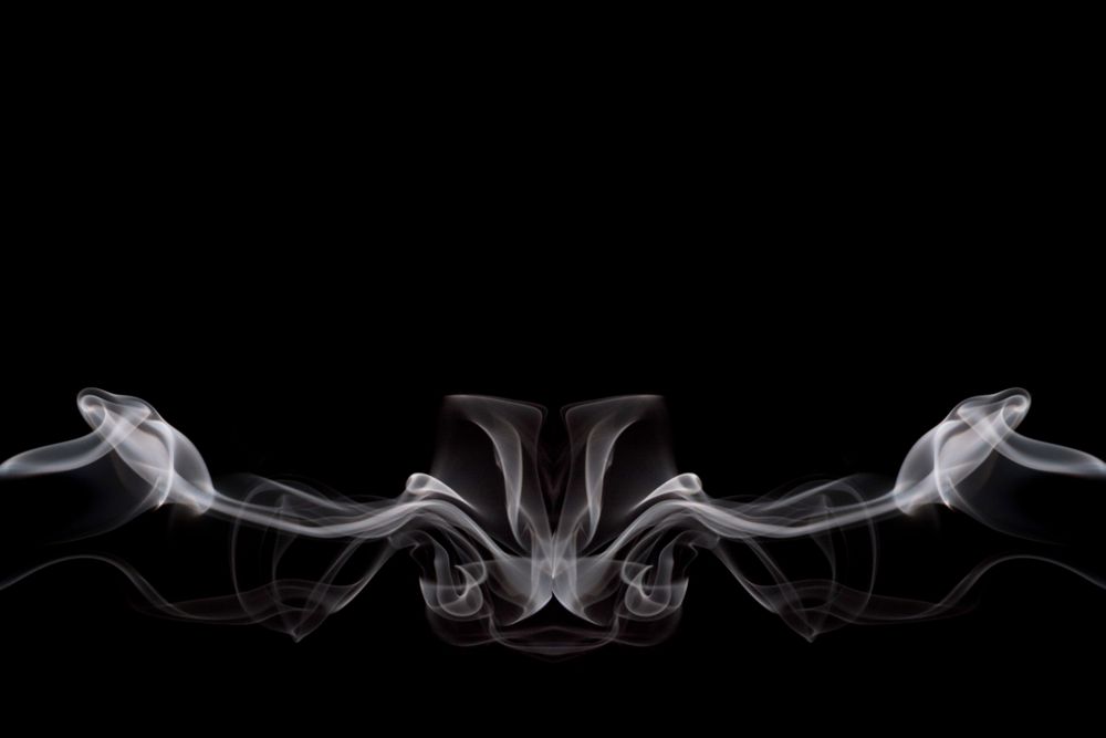 Abstract smoke moving on dark background