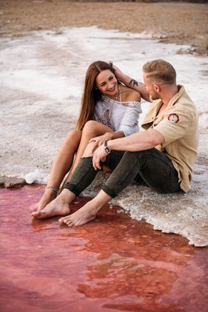 adorable couple on an amazing beach with pink water