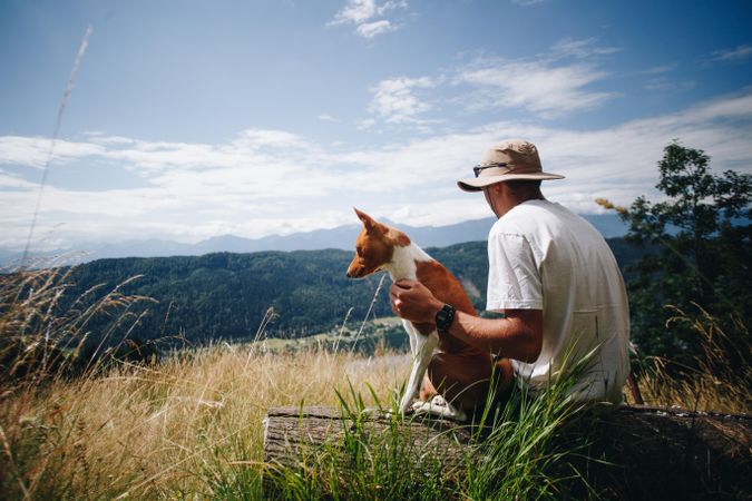Man and dog overlooking scenic view