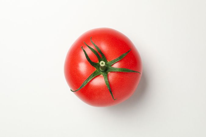Fresh tomato on neutral background, top view and close up