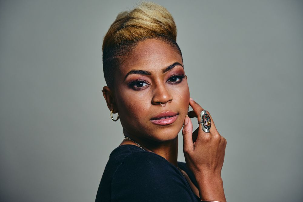 Portrait of Black woman with short blonde hair in grey space