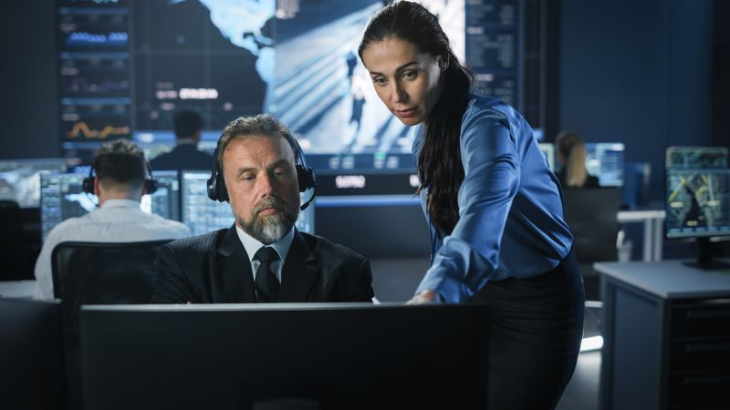 Intelligence Operatives Analyze Data in High-tech Command Center.
