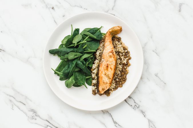 Served salmon steak with beans and couscous