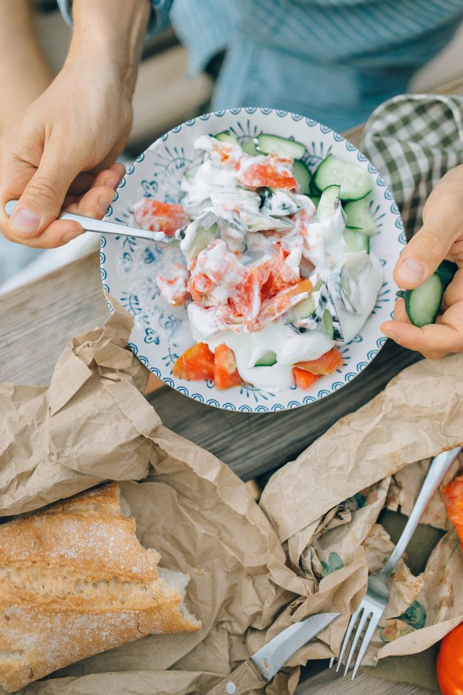 Cropped image of person eating salad