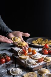 Homemade ravioli made with parmesan cheese, tomato and basil.