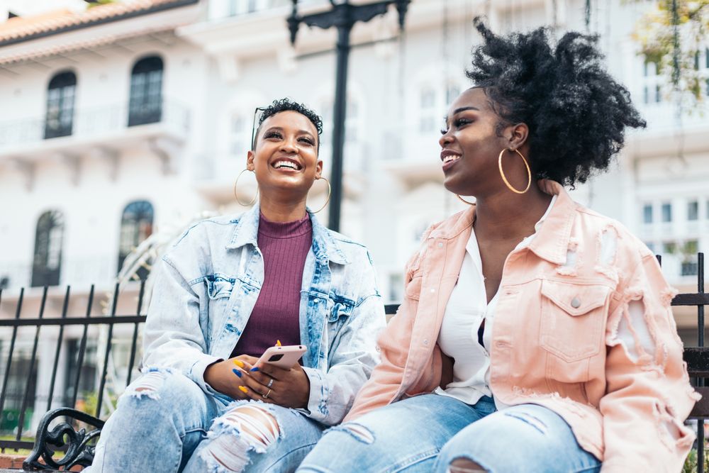 Black women talking and laughing in the city