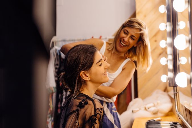Makeup artist doing makeup for young female artist