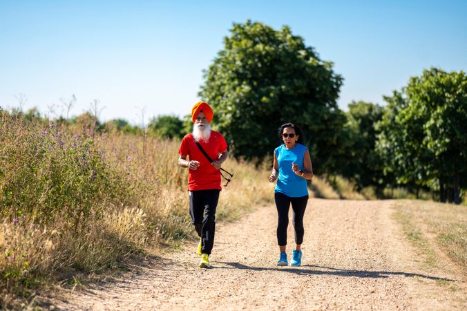 Mature Sikh couple jogging