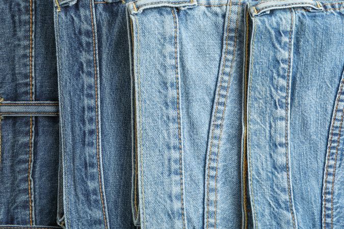 Jeans of different colors as background, space for text