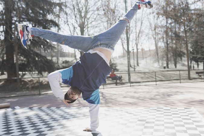 Man dancing break dance in park