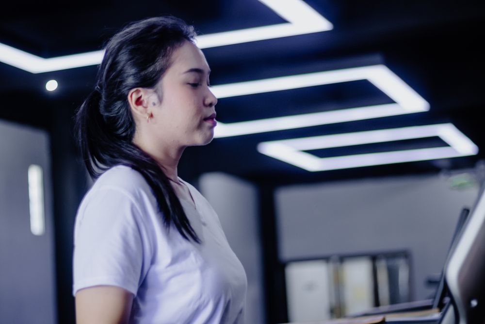 Focused Woman on Treadmill: Mindful Fitness and Inner Strength