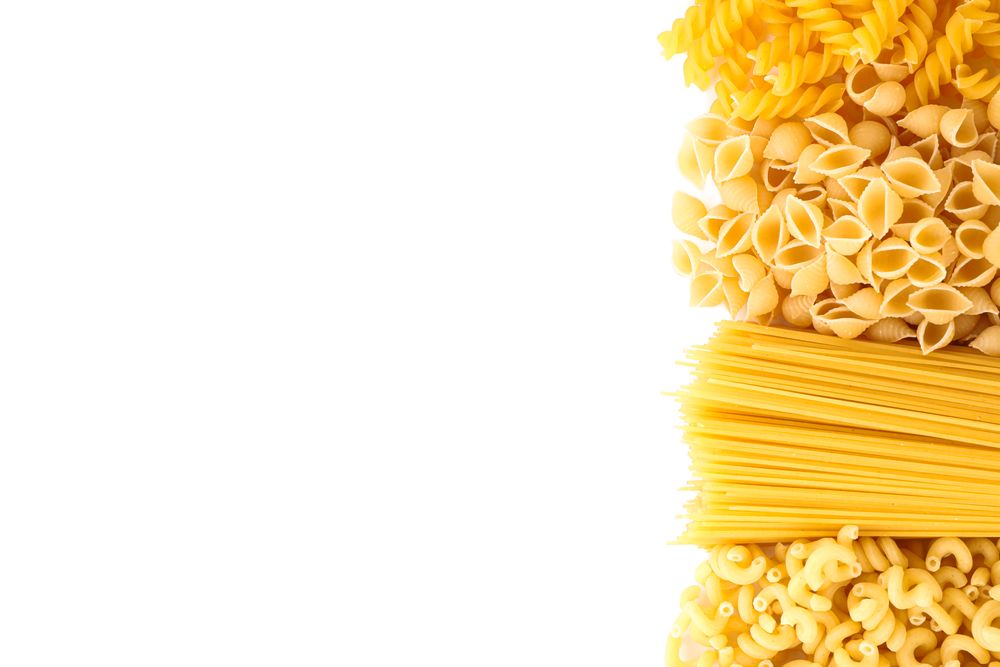 Pasta isolated on light background, top view. Dry uncooked whole pasta