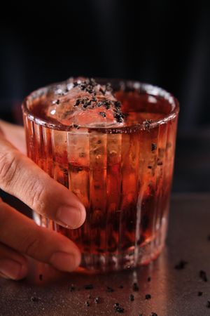 Anonymous barman serving cocktail on counter