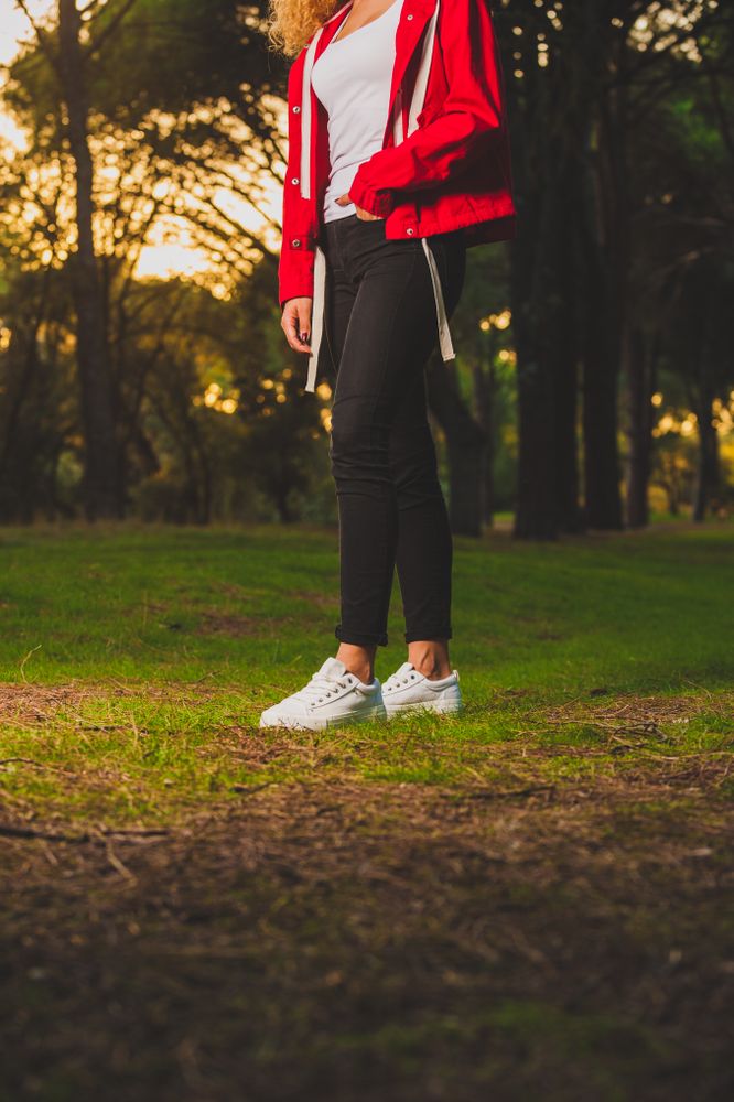 Crop sportive woman standing on meadow