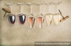 Glasses of wine laying on grey background with corkscrew, copy space 5rPW7b