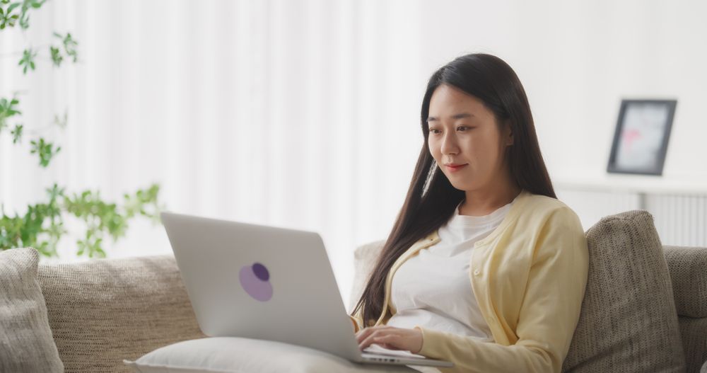Young South Korean Woman Engaged and Connected Online, Enjoying Leisure Time with Her Smartphone