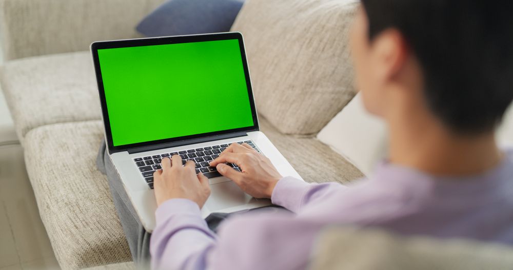 Over the Shoulder Footage of an Anonymous Male Working from the Comfort of Home
