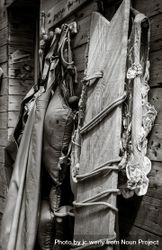 Close up of fishing clothes and board resting on wooden building, monochrome 0JdDp4