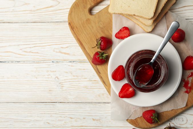 Composition with strawberry jam on wooden background, top view