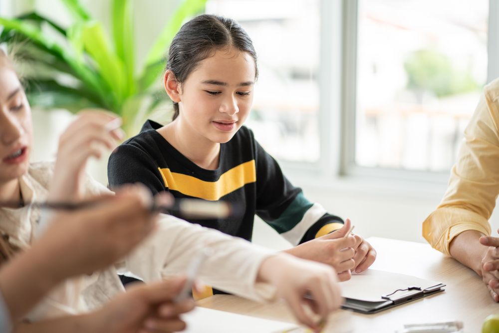 Curious female student with notepad in class
