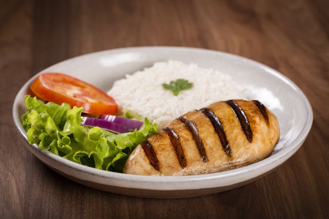 Grilled chicken with salad and rice.