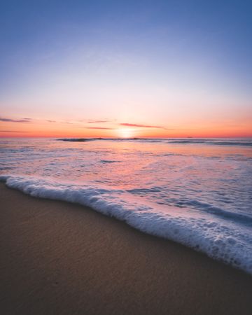 Ocean waves on shore during sunset