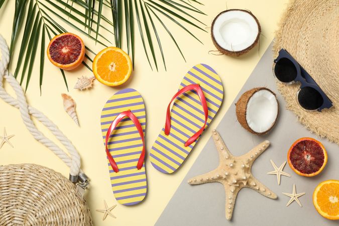Summer vacation accessories on two tone background, top view