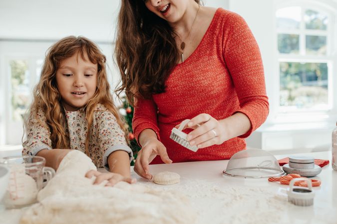 Mother and daughter preparing Christmas cookie dough