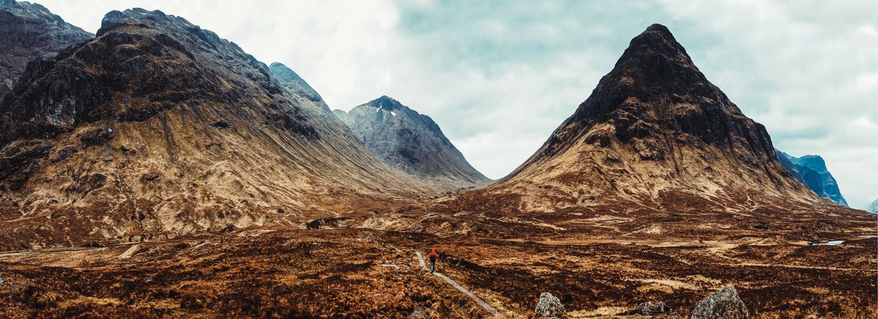 Person walking through picturesque mountains