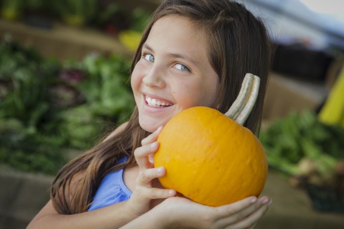 Girl Having Fun with the Pumpkins at Market