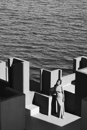 Woman in blue fur dress on the roof of a building