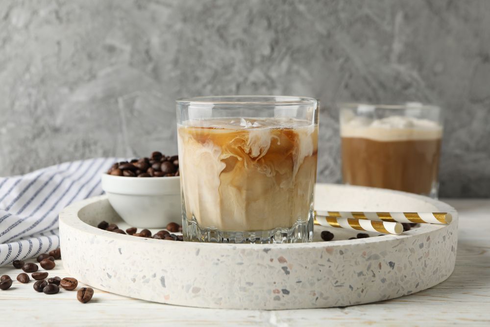 Composition with tray with ice coffee on wooden background